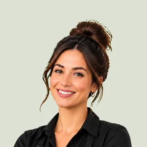 A smiling beauty professional in a black apron